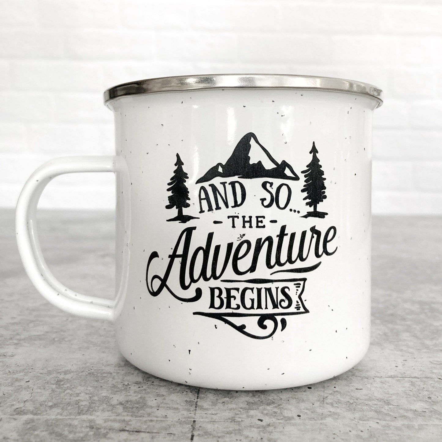 And So...The Adventure Begins design on a white enamel mug