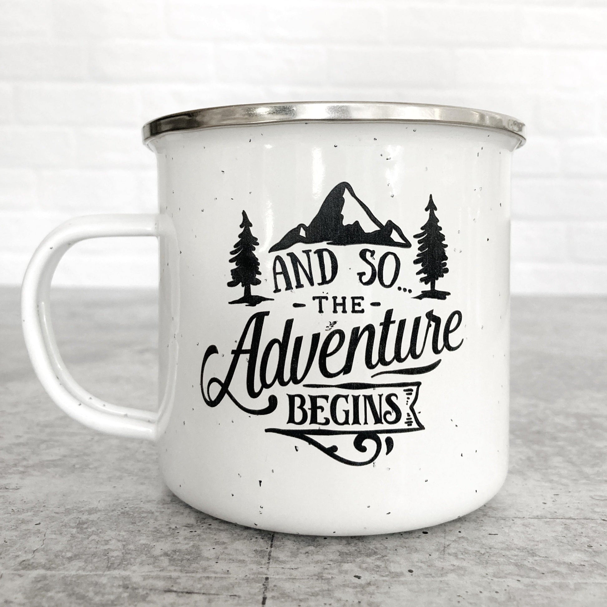 And So...The Adventure Begins design on a white enamel mug
