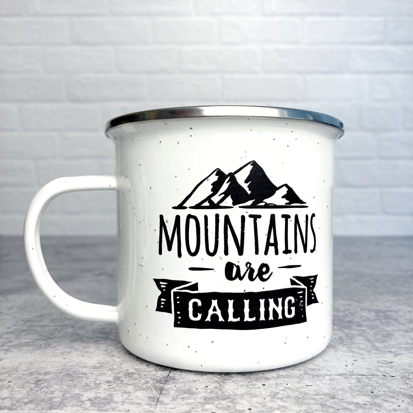 Mountains are calling design on a white enamel mug